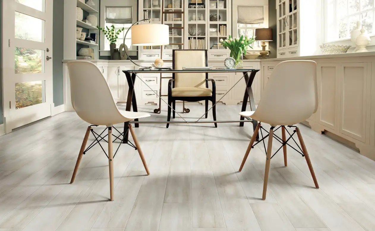 Desk and chairs with tile flooring, warm lighting.